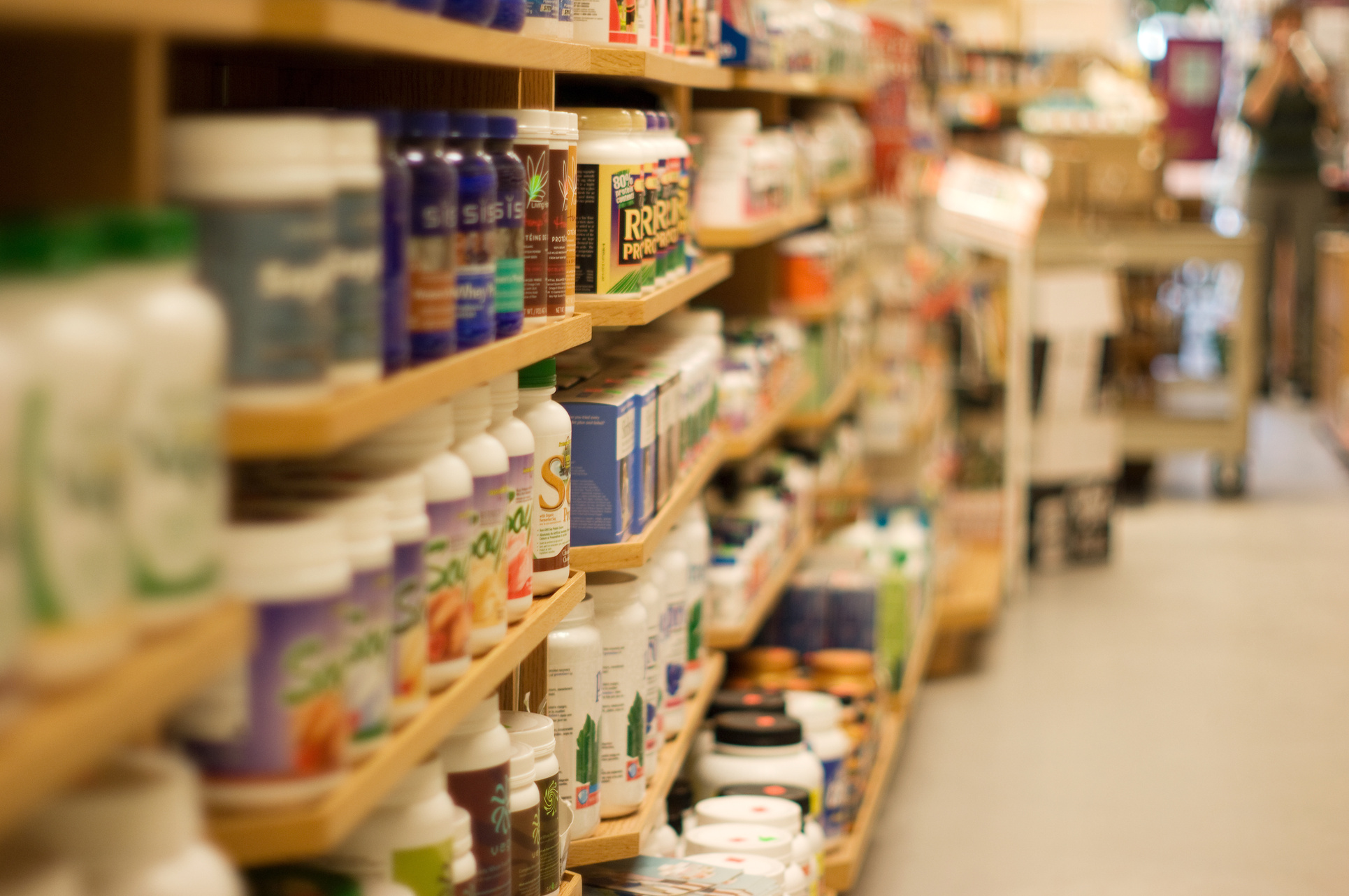 Products on shelves in aisle of health foods store
